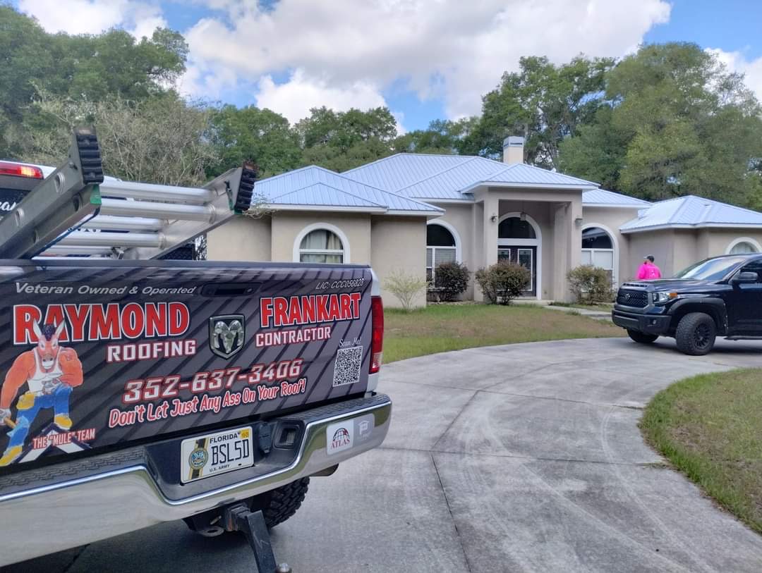Raymond Frankart Roofing branded truck parked at completed standing seam metal roof job