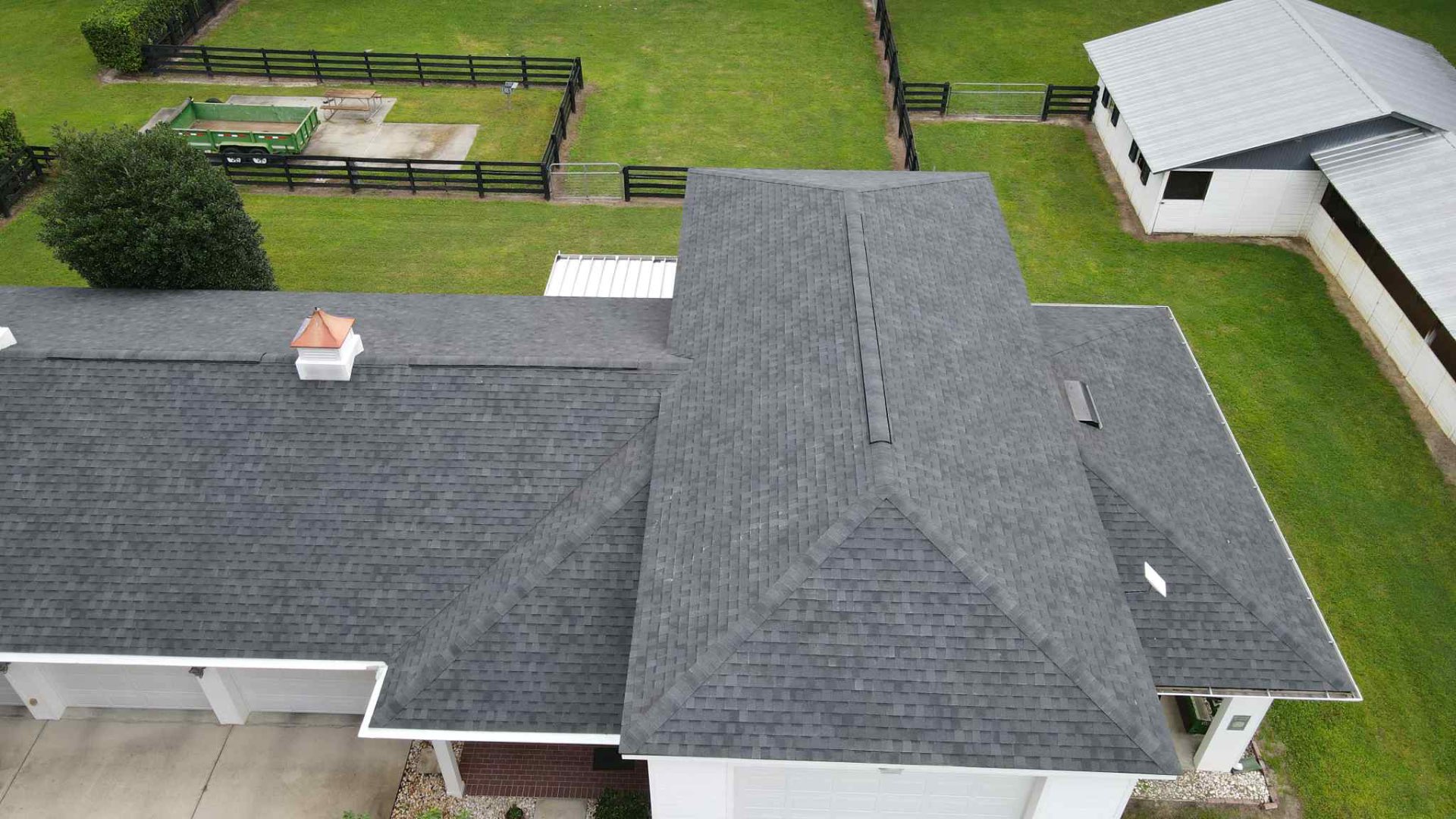 Top-down view of charcoal architectural shingles with copper-capped cupola on Florida horse farm home